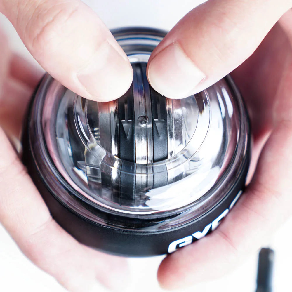 Close-up of hands holding Aznolt gyro ball hand exerciser, home fitness gear