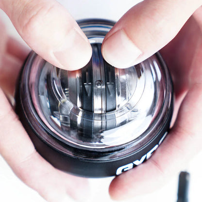 Close-up of hands holding Aznolt gyro ball hand exerciser, home fitness gear