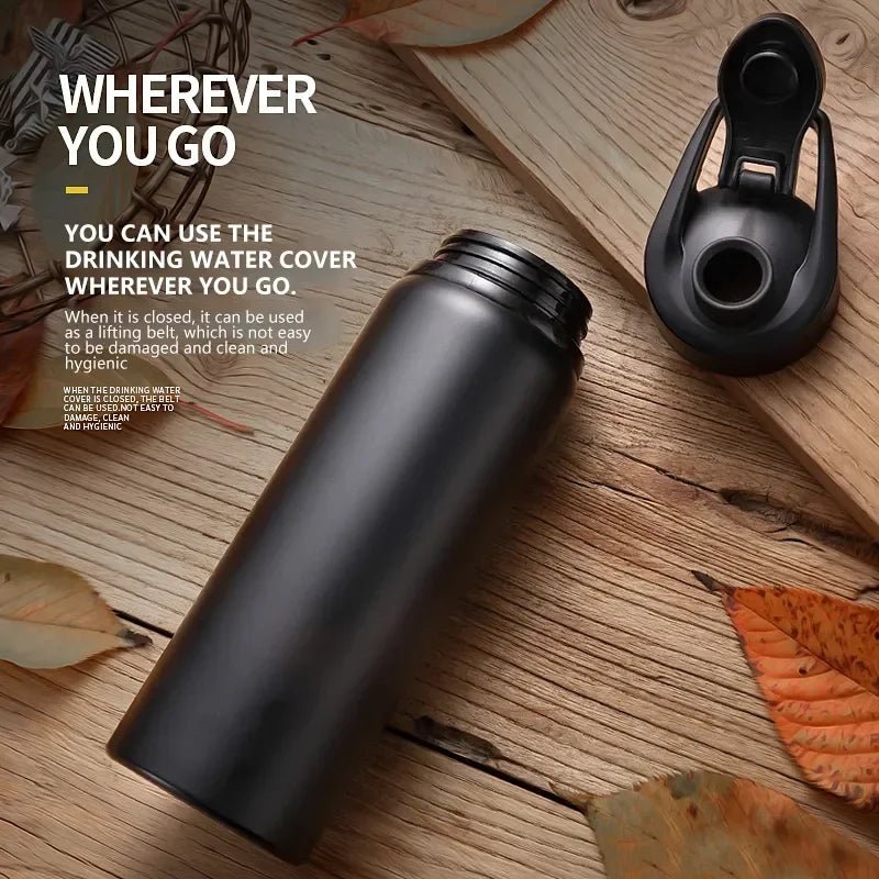 Black Aznolt water bottle with open lid on rustic wood, premium fitness gear, outdoor setting